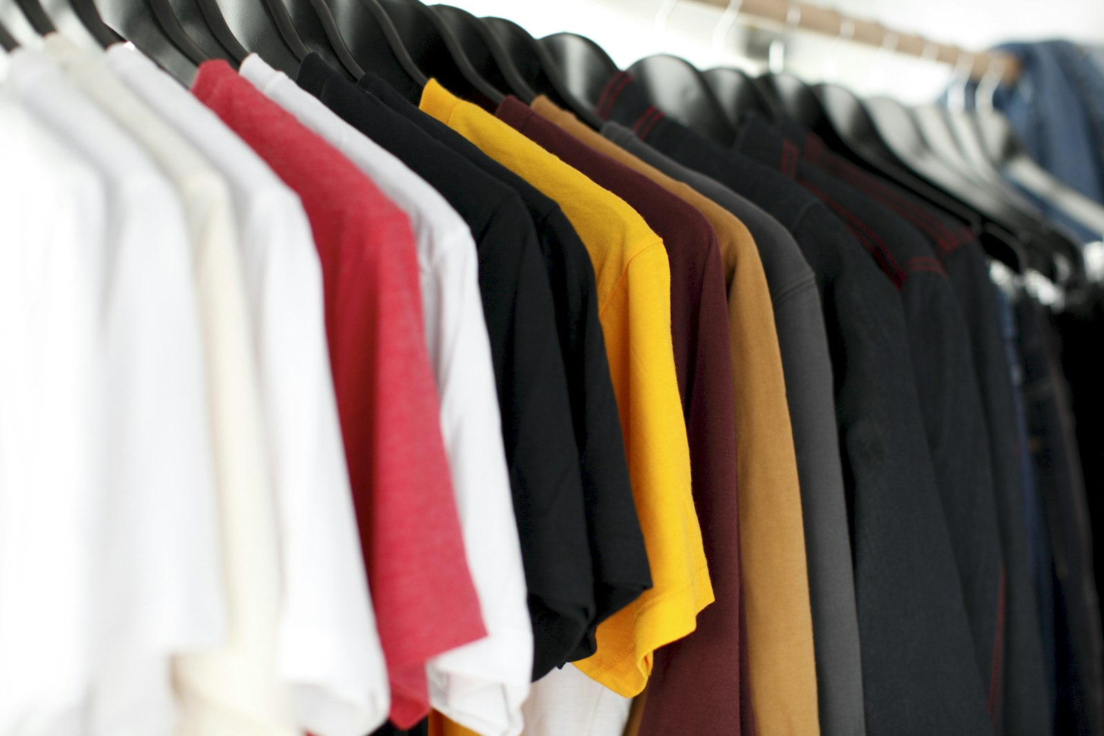 A man reviewing a curated style moodboard alongside his wardrobe during a consultation